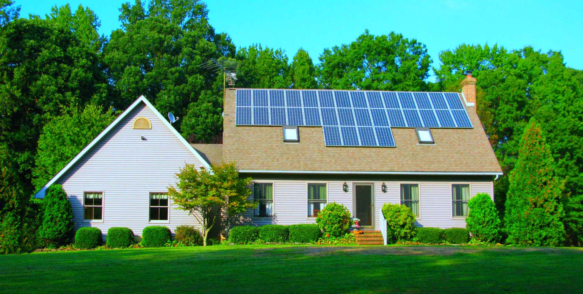image of the house with solar panels in the roof